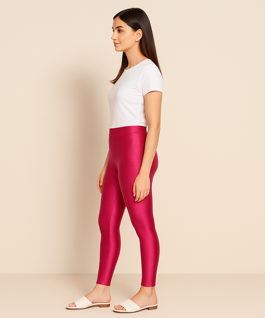 Woman wearing red leggings and a white shirt on a beige background