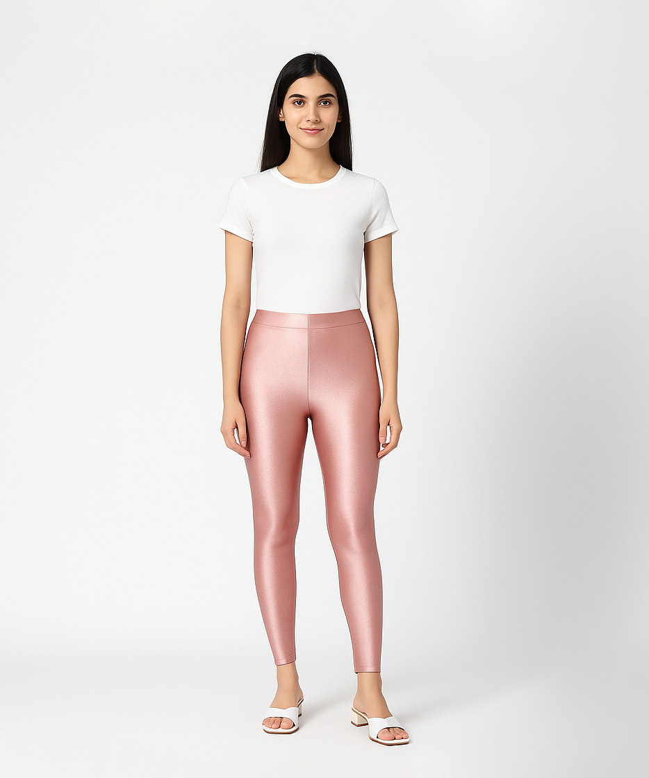 Woman wearing pink leggings and a white top on a white background